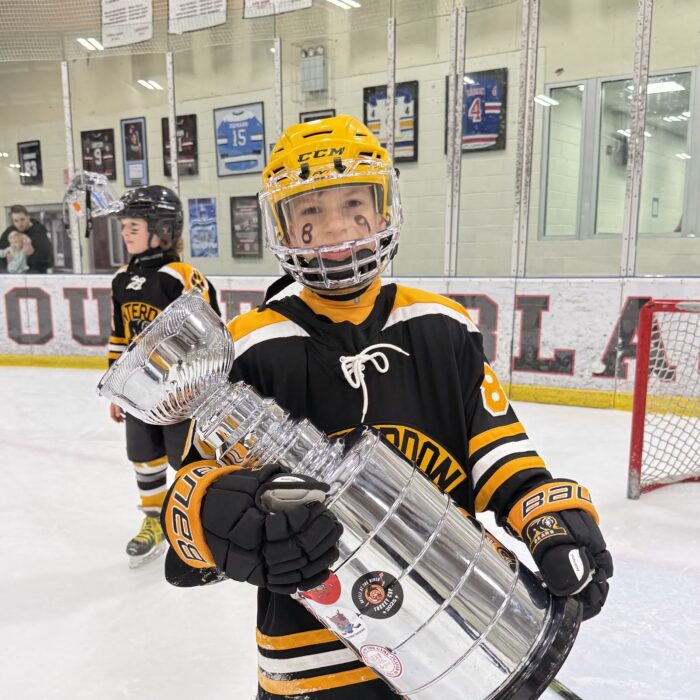 Owen Markowycz holding a hockey trophy